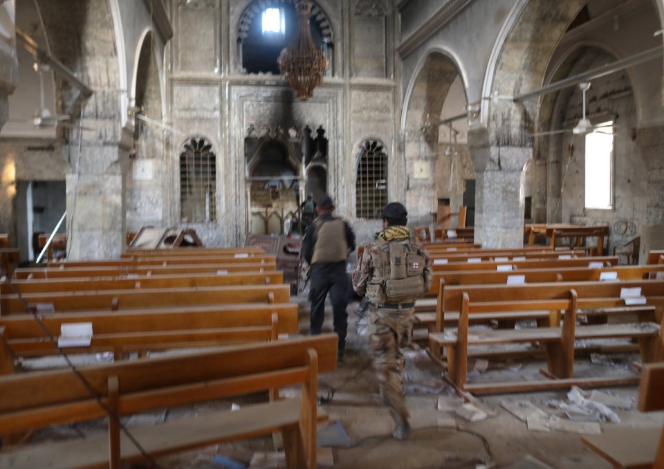  Iraqi special forces soldiers walk inside a church damaged by Islamic States fighters