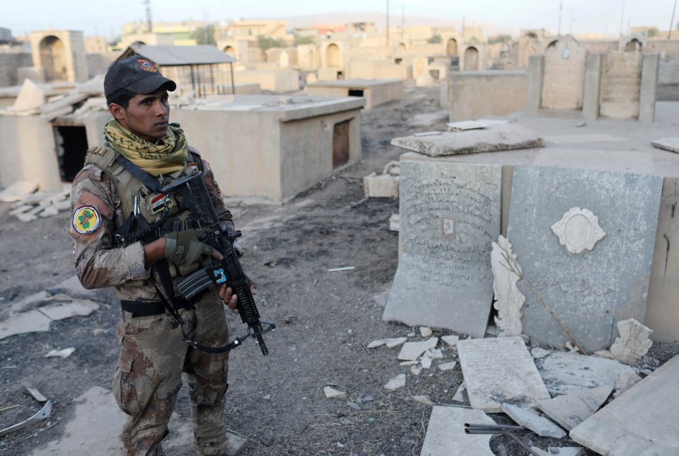  An Iraqi special forces soldier stands in a Christian cemetery