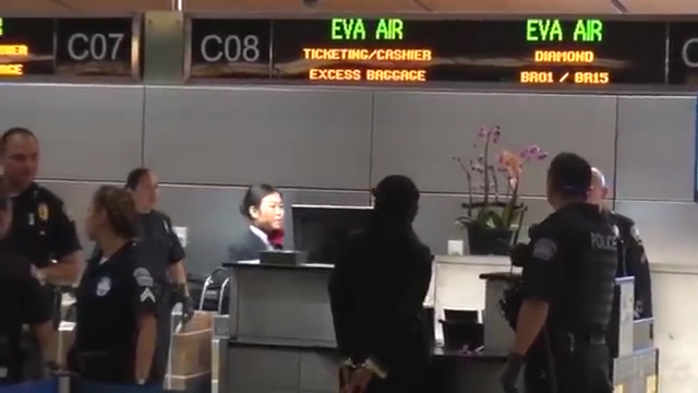  She was later filmed being handcuffed at the check-in counter