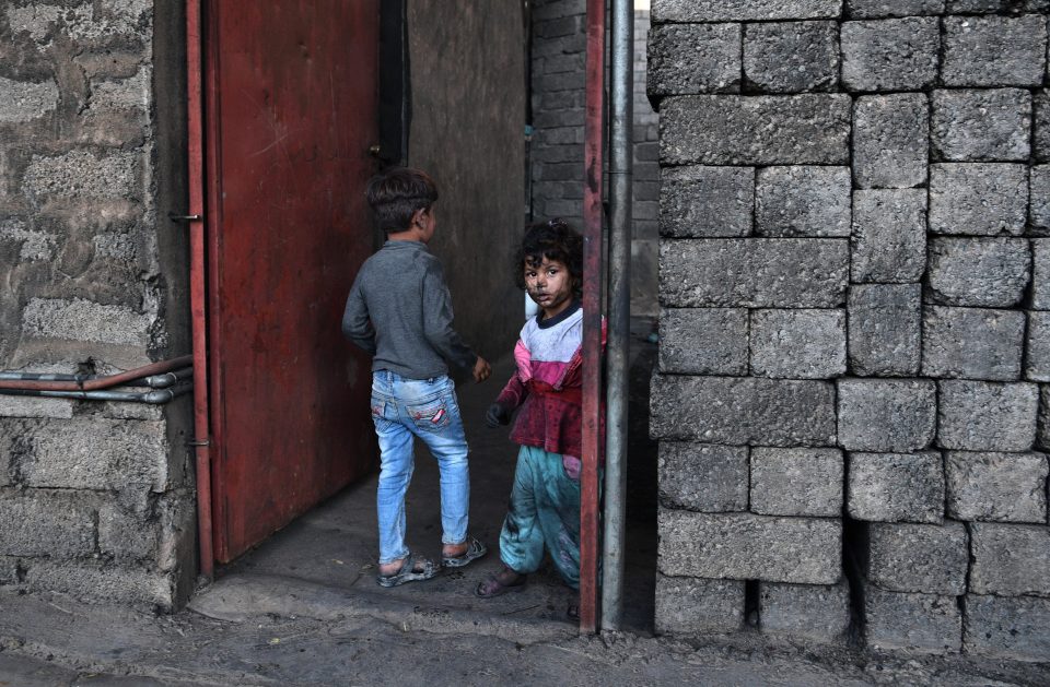  A young girl has her face blackened with soot after the oil fields were set on fire