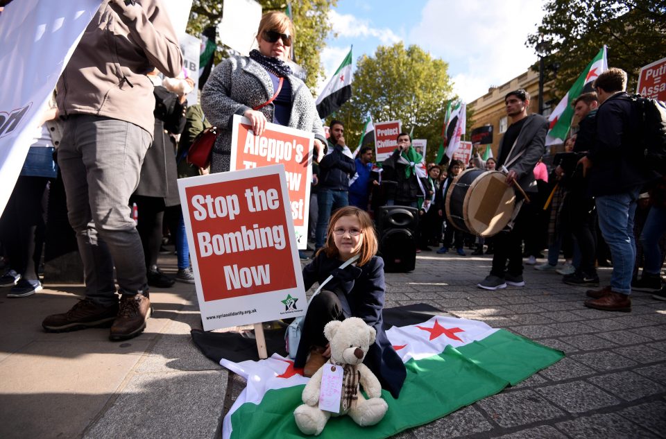  Protesters gather in London with 'Stop the bombing now' plaques