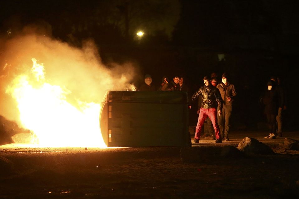  Migrants torched cars last night as they protested against the camp being demolished