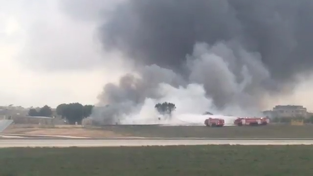  Fire crews work to extinguish flames after a light aircraft, reportedly carrying EU border officials, crashes in Malta