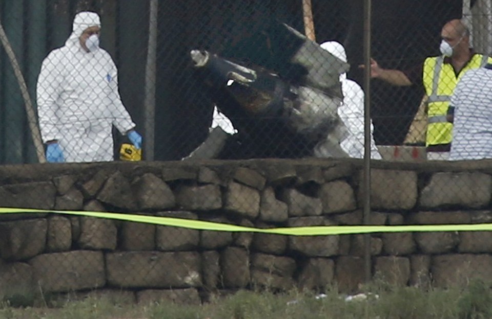  A large piece of debris is seen lying next to a wall at the airport