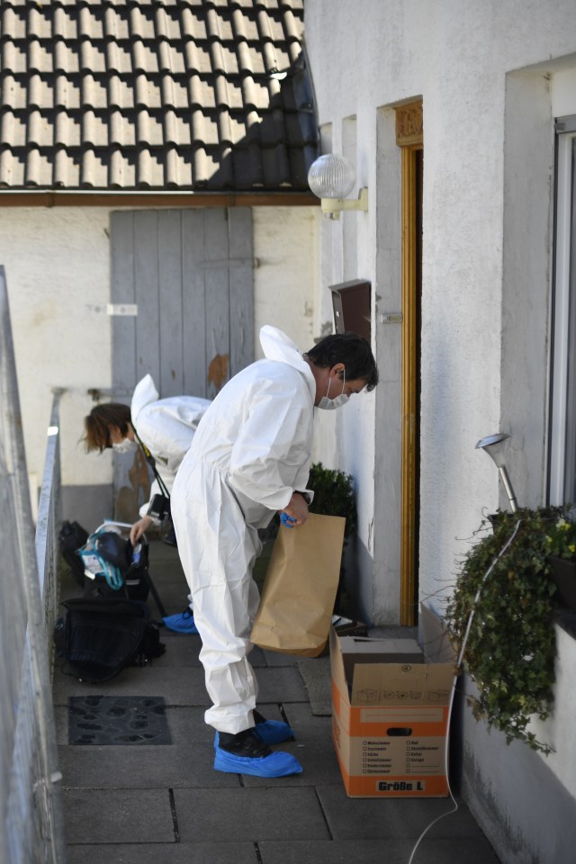  Forensic police scour the property following the discovery of one of the victims