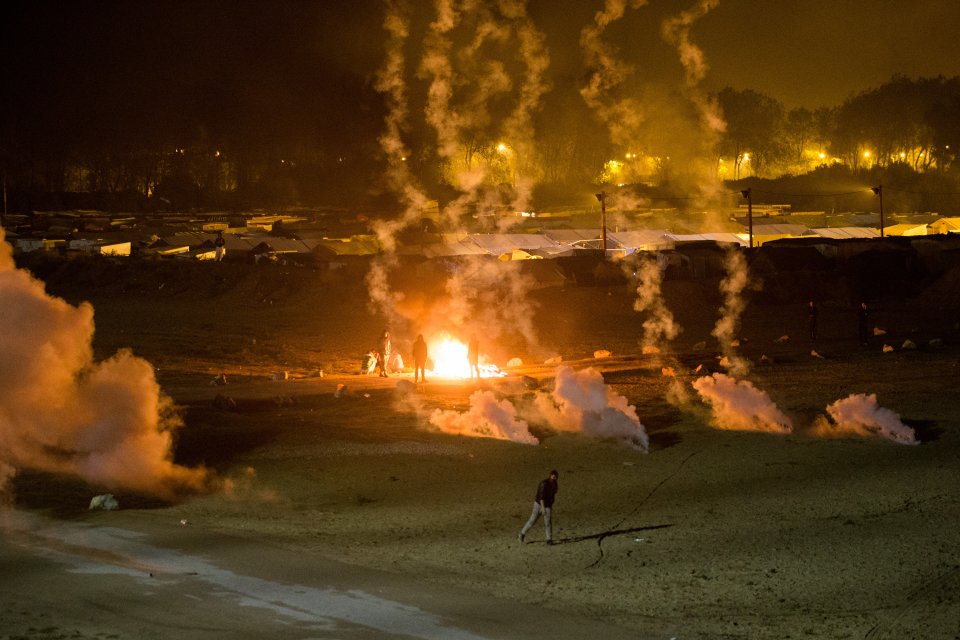  Migrants threw rocks at police who fired smoke grenades back inside the Jungle Camp last night