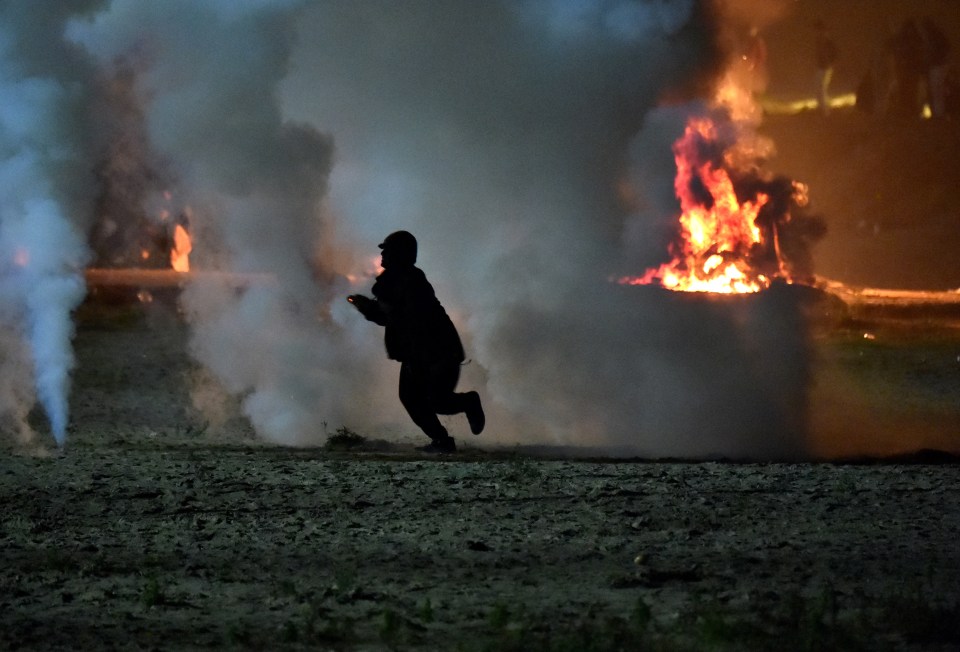  People desperately clinging on to their homes in the 'jungle camp' fought back against French police