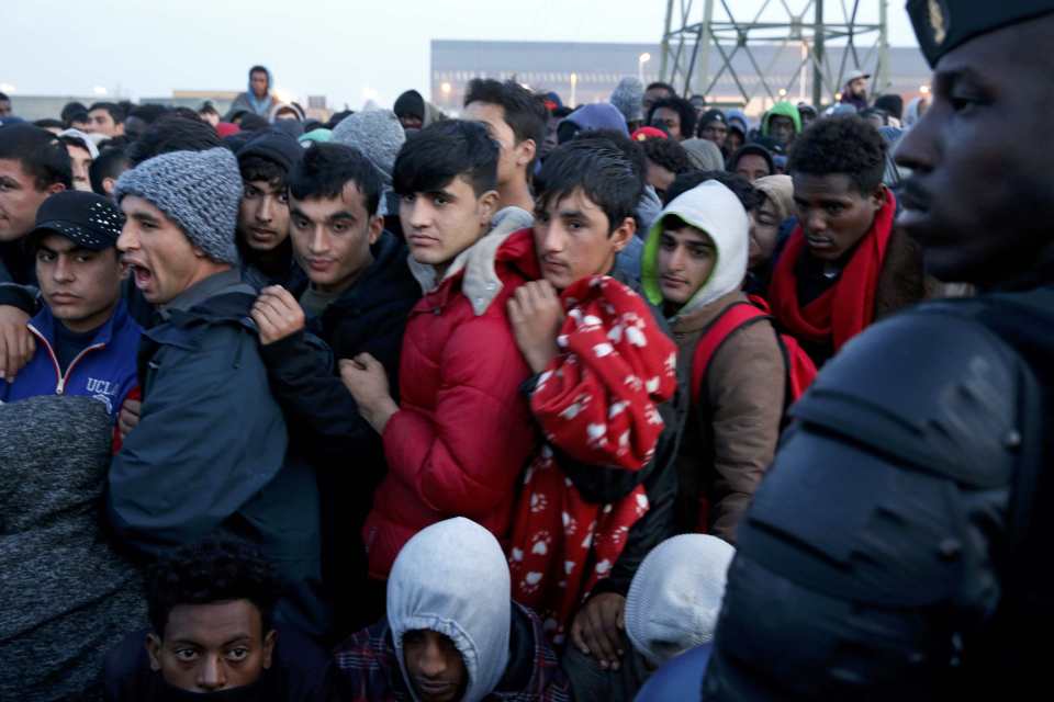 Migrants who claim to be minors wait for their registration and evacuation from the camp that will be dismantled called the "Jungle" in Calais