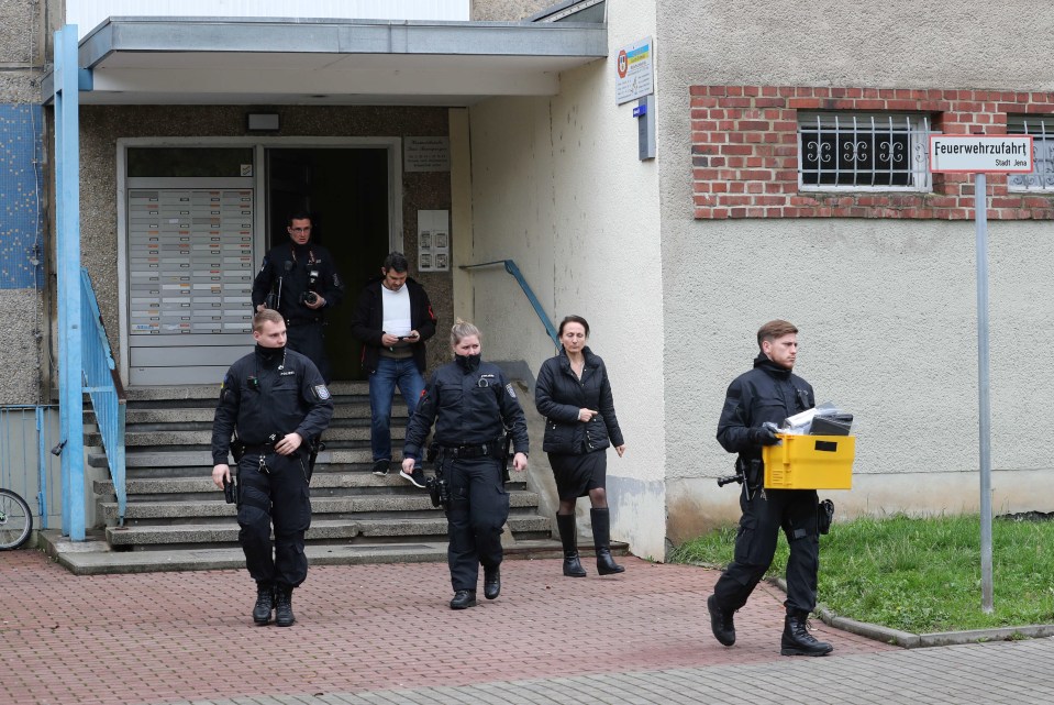  Police leave a residential building after the anti-terror operation in Jena, eastern Germany