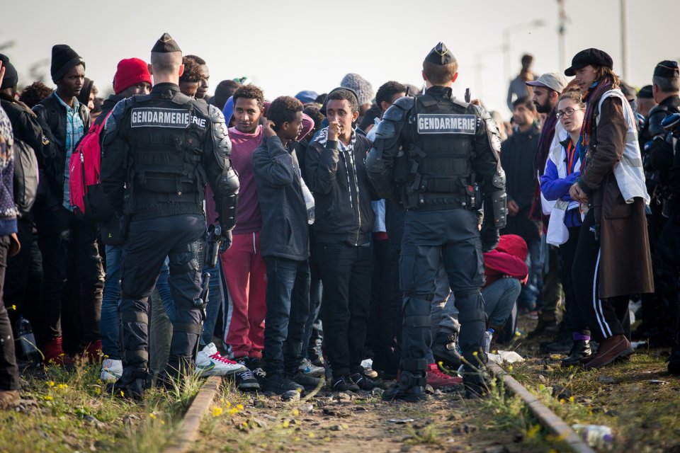  French police monitored the crowds as the demolition of the Jungle continued today