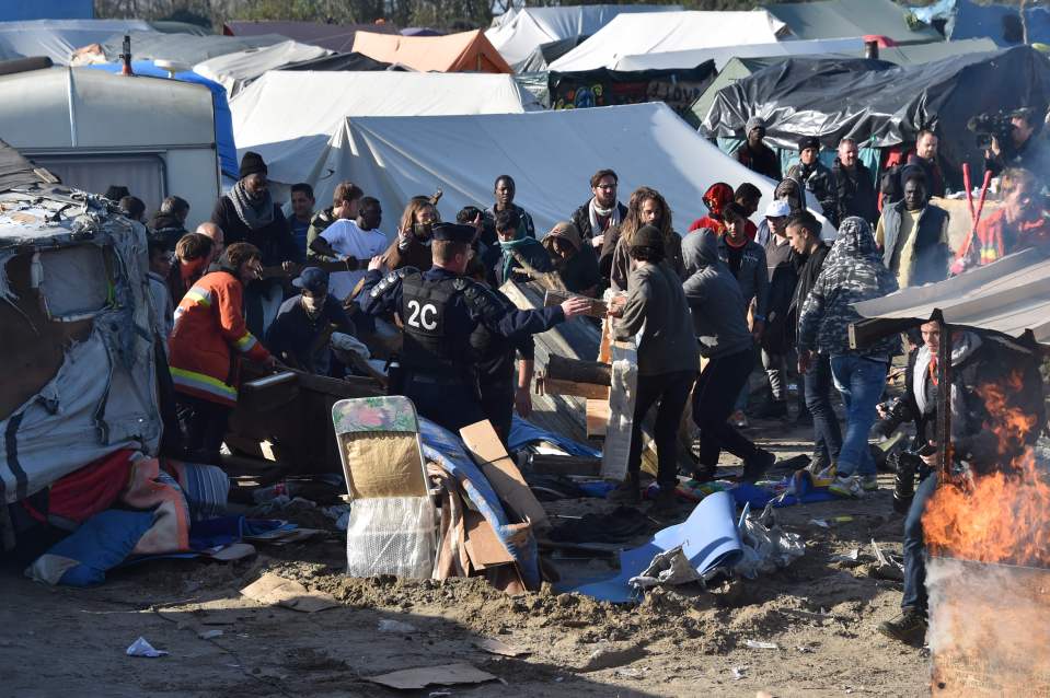 Scuffles between riot police an migrants took place as demolition crews moved in