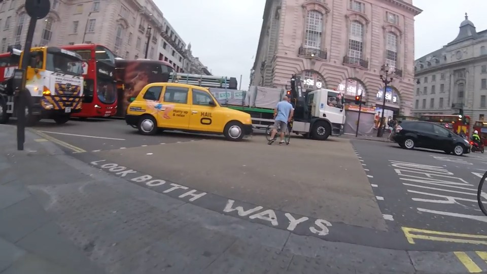  The driver repeatedly shouts, swears and points at the cyclist in the heated exchange in the middle of the street