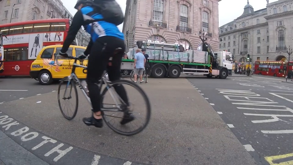  Footage taken by biker Ross Holdsworth shows a minor prang between the cyclist and the taxi as they pull away from a set of traffic lights