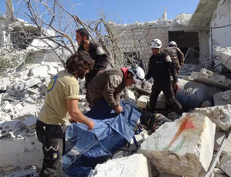  Looking for life among the dead... Syrian rescuers look for survivors following the bloody attack in the village of Hass