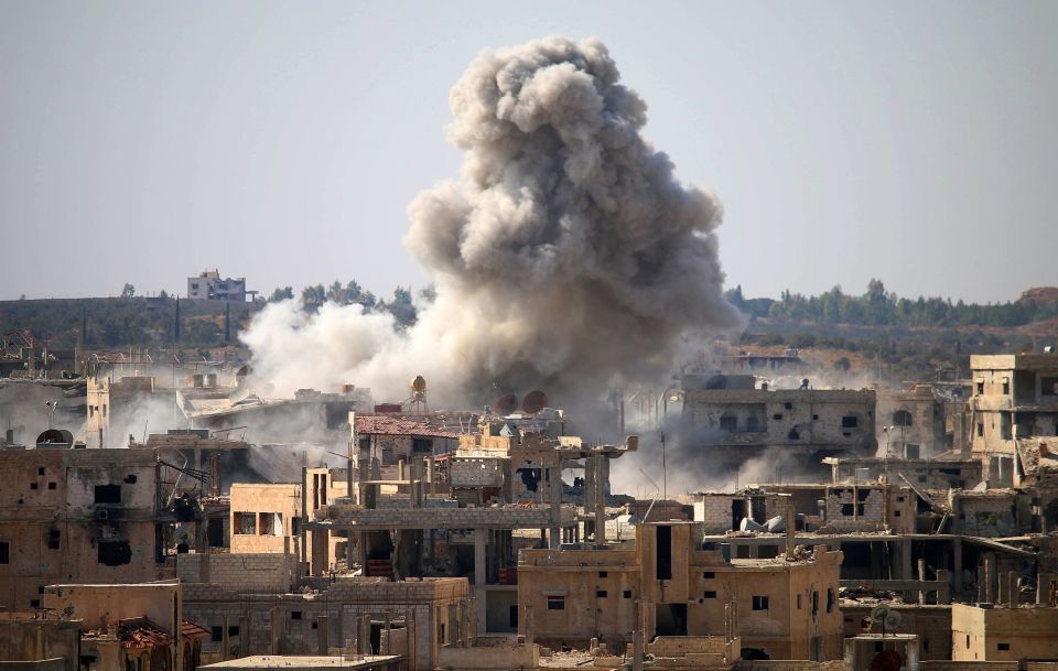  Smoke billows following an air strike by Syrian government forces in a rebel-held area of Daraa