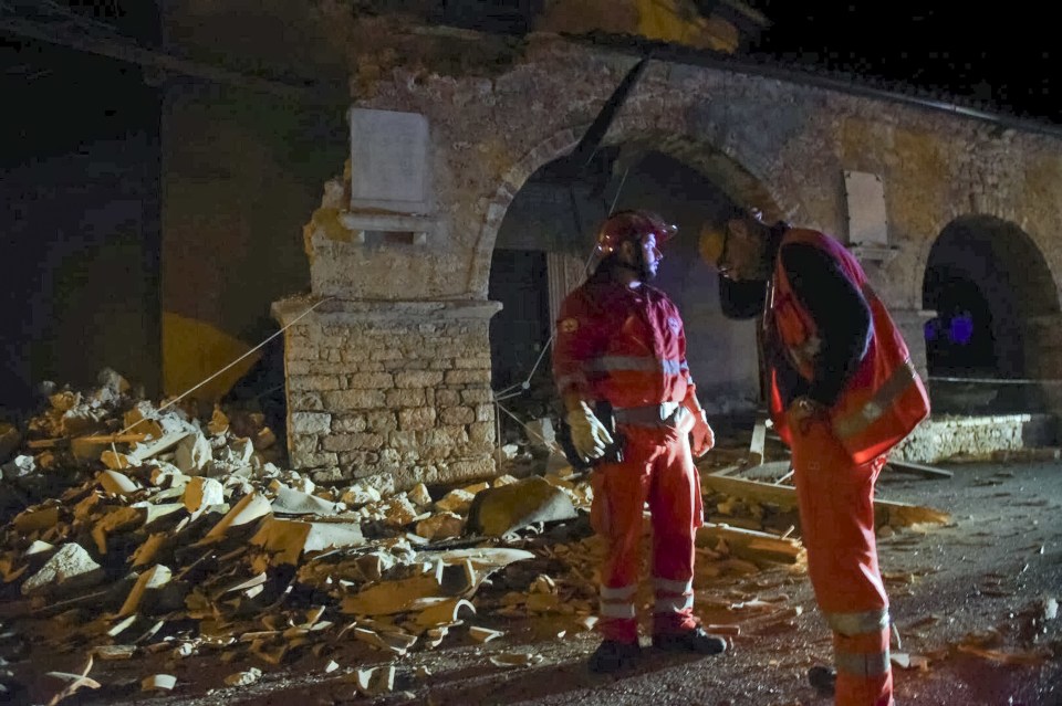  Rescuers stand by rubble in the village of Visso, central Italy