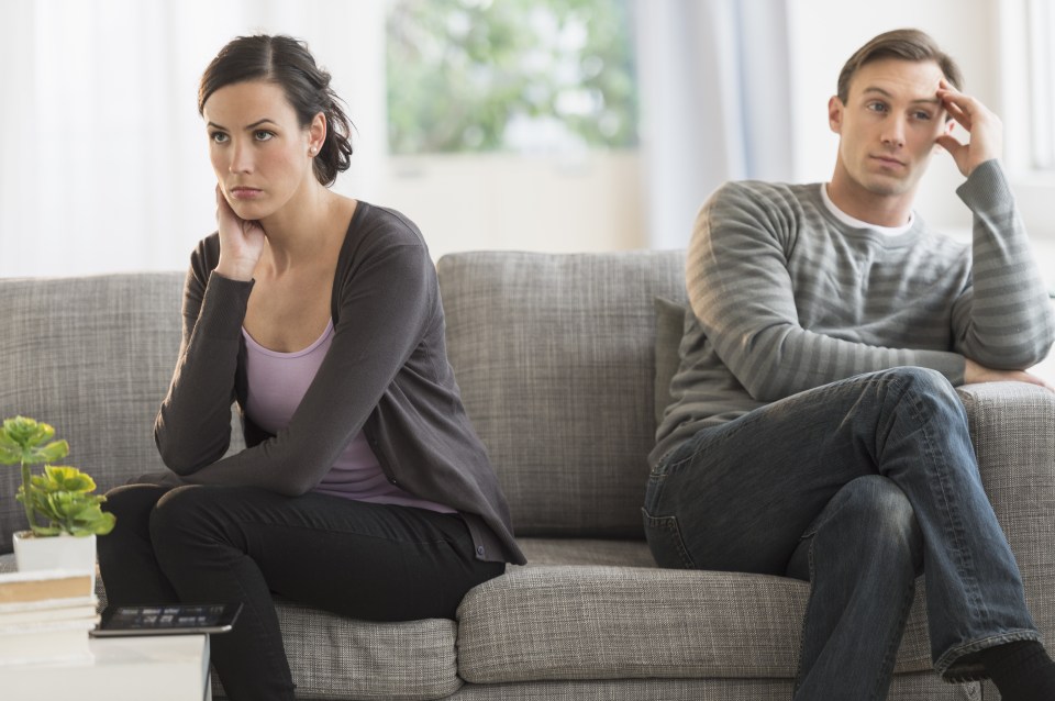 Couple sitting on a sofa not talking