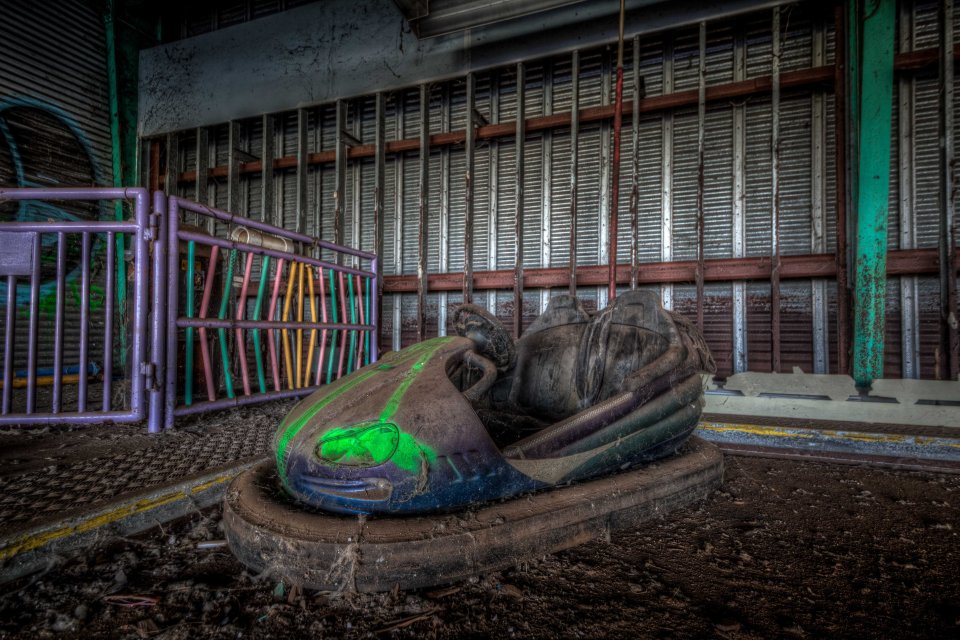 A dodgem is surrounded by a thick layer of dirt