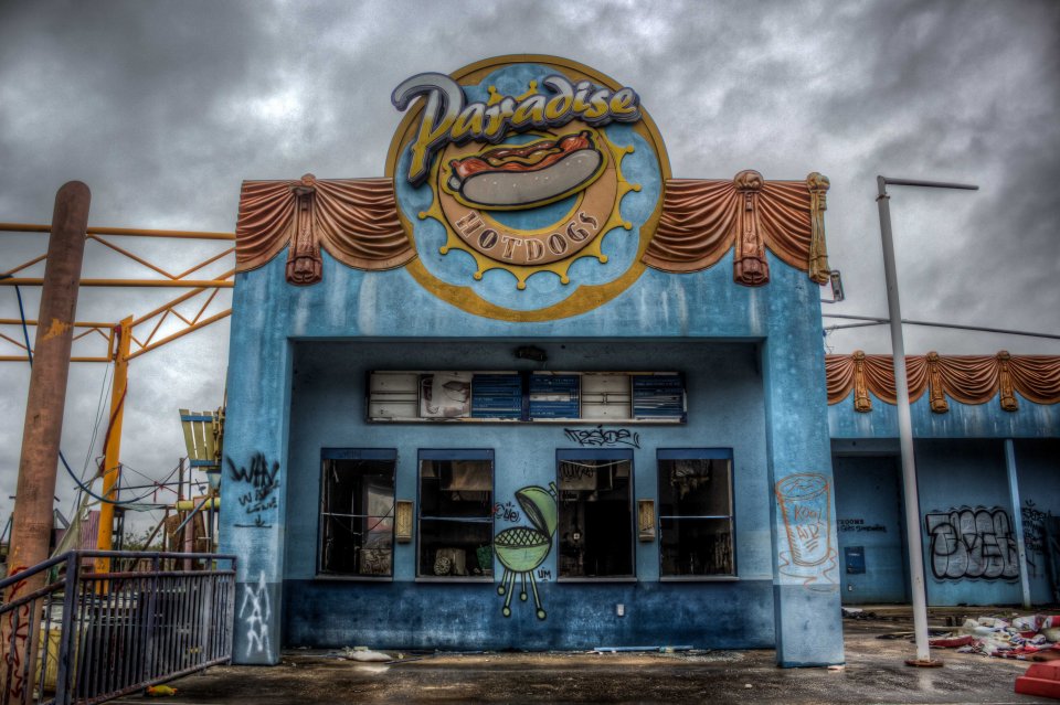 A hot dog stall is caked in graffiti