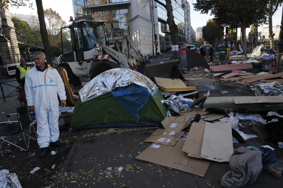  Workers demolish the Paris camp after a police operation to protect them from migrants