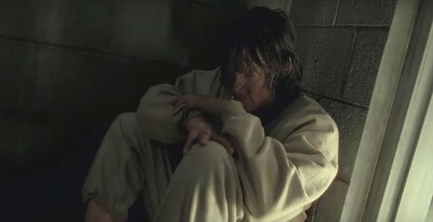 Daryl cowers in a cell after being kidnapped by Negan