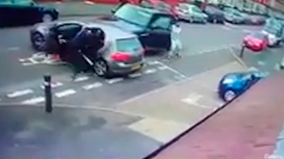  Angry passengers begin to pour out of the silver car, with one man clearly seen to be holding a bat