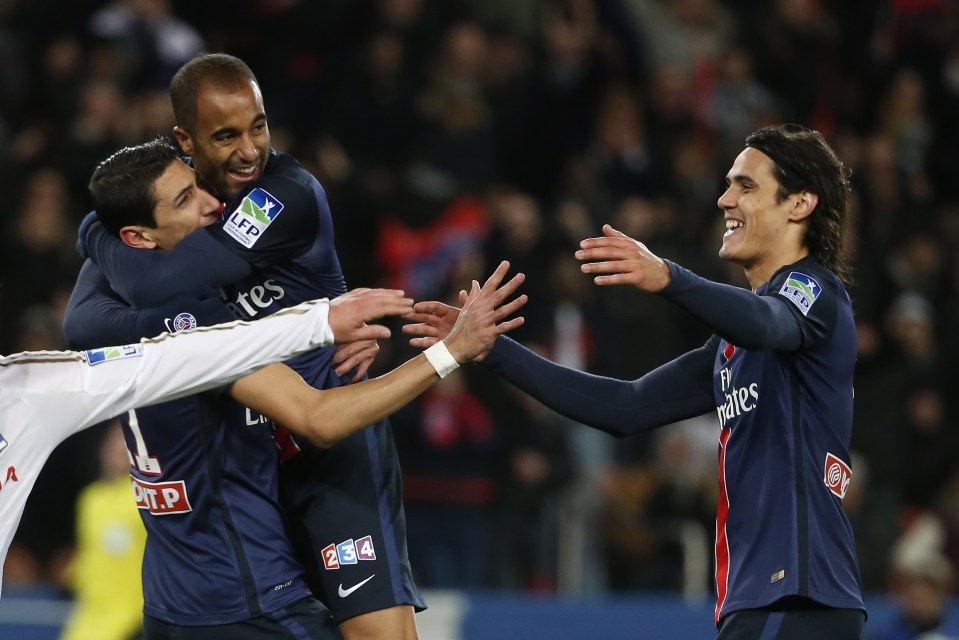 Paris Saint-Germain's Brazilian midfielder Lucas Moura (C) is congratulated by his teamates Paris Saint-Germain's Argentinian forward Angel Di Maria (L) and Paris Saint-Germain's Uruguayan forward Edinson Cavani (R), after he scored a goal during the French League Cup quarter final football match between Paris Saint-Germain (PSG) and Lyon (OL) on January 13, 2016 at the Parc des Princes stadium, in Paris. AFP PHOTO / THOMAS SAMSON / AFP / THOMAS SAMSON (Photo credit should read THOMAS SAMSON/AFP/Getty Images)