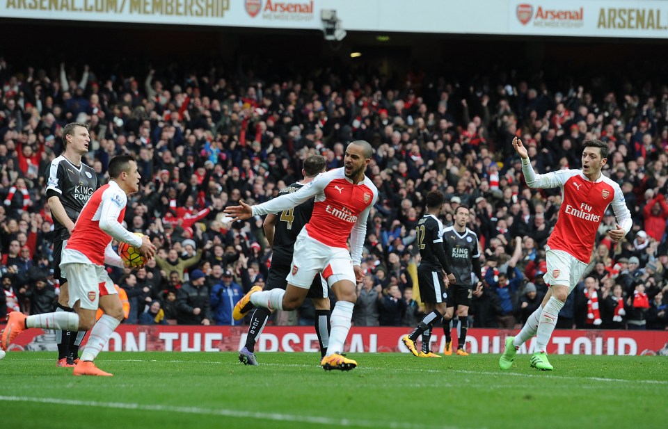 LONDON, ENGLAND - FEBRUARY 14: (2ndR) Theo Walcott celebrates scoring the 1st Arsenal goal with (L) Alexis Sanchez and (R) Mesut Ozil during the Barclays Premier League match between Arsenal and Leicester City at Emirates Stadium on February 14, 2016 in London, England. (Photo by Stuart MacFarlane/Arsenal FC via Getty Images)