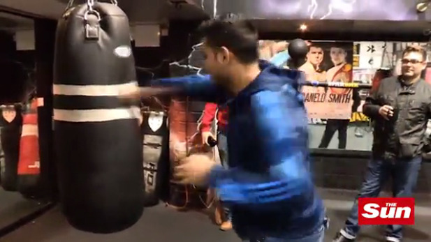 Amir Khan shows off his repaired hand as he has a go on the punching bag