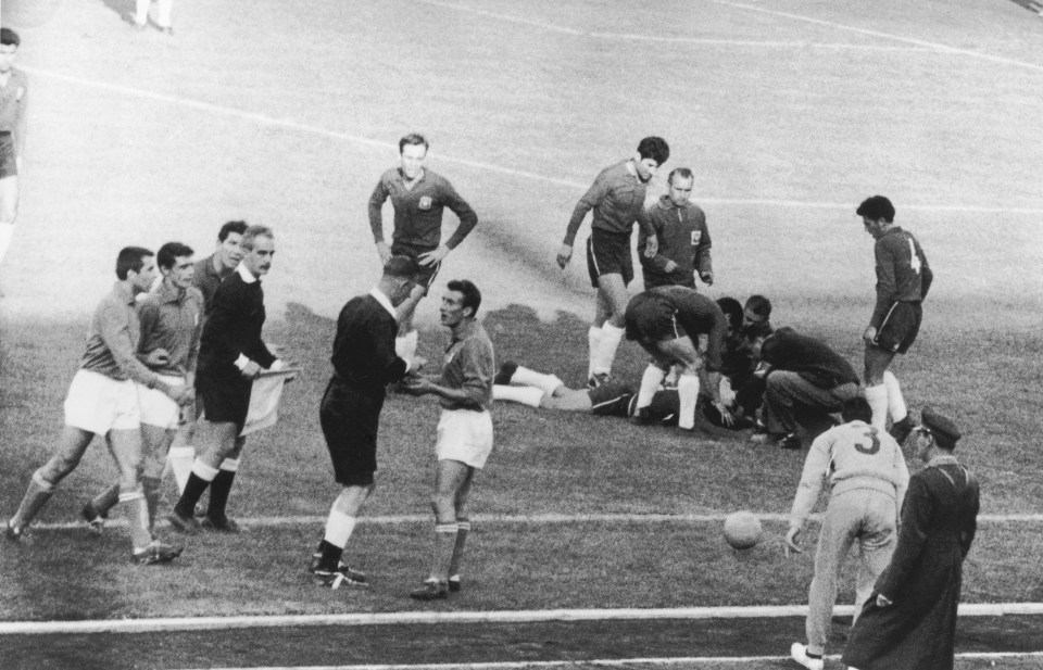  Italian player, Mario David, is sent off while a Chile player lies injured on the floor