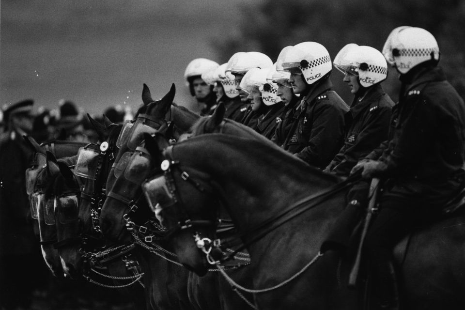 Under fire ... miners and their supporters accuse police of brutality after charging them with horses 