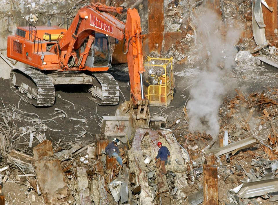  Workers begin to clear the rubble in the aftermath of the New York terrorist attacks