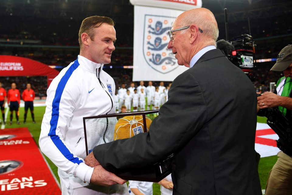 Rooney receiving his 100th cap from Sir Bobby Charlton against Slovenia at Wembley in 2014