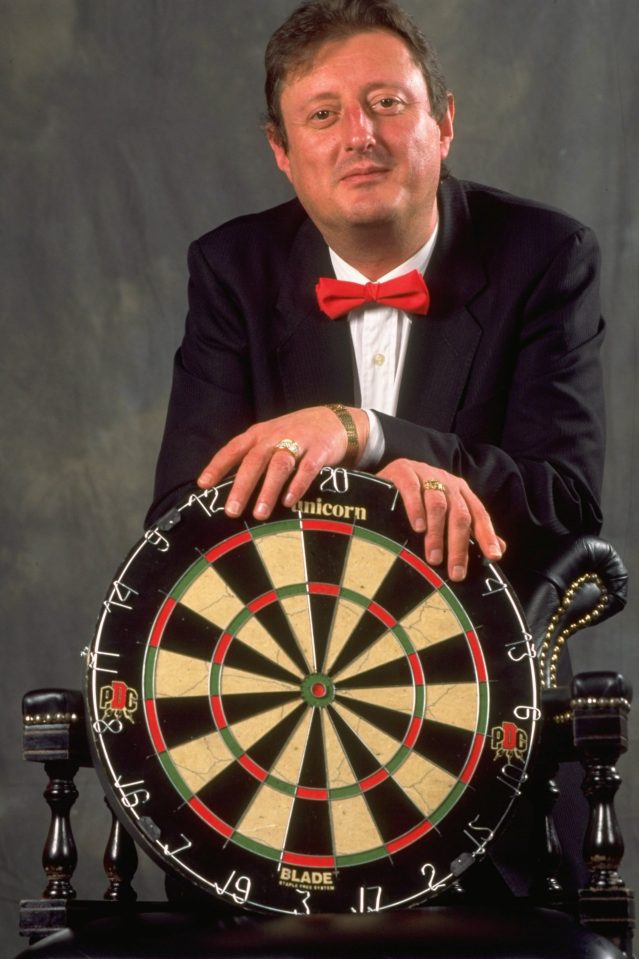 Eric Bristow poses with a dart board during the PDC World Darts Championships in Purfleet in Essex, England, in 1999