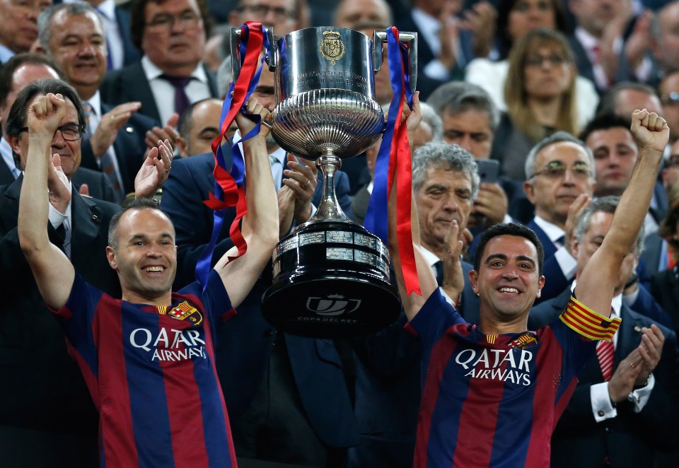 Barcelona's Andres Iniesta, left, and Xavi Hernandez