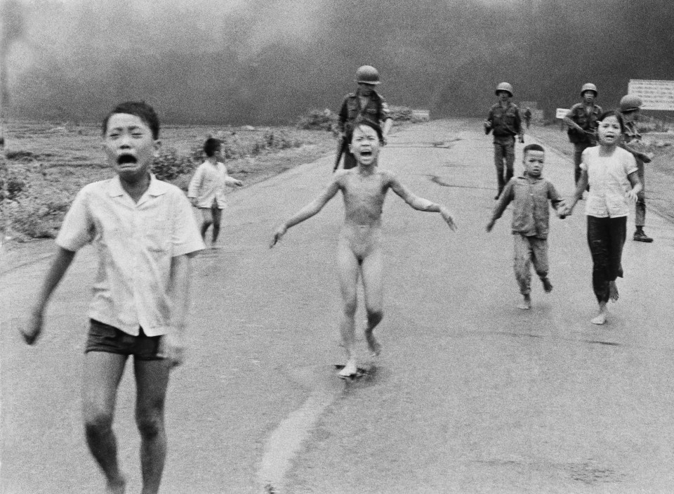 South Vietnamese forces follow after terrified children, including 9-year-old Kim Phuc, center, as they run down Route 1 near Trang Bang after an aerial napalm attack on suspected Viet Cong hiding places. A South Vietnamese plane dropped its flaming napalm on South Vietnamese troops and civilians. The terrified girl had ripped off her burning clothes while fleeing