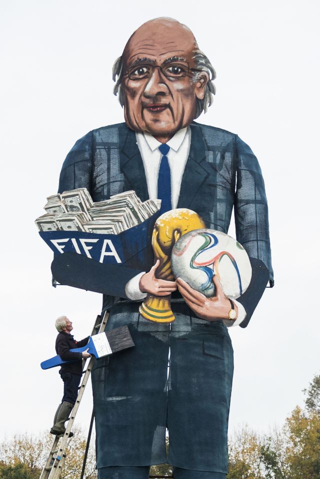 British artist Frank Shepherd of the Edenbridge Bonfire Society poses putting the finishing touches to a giant effigy of the suspended president of FIFA Sepp Blatter in 2015