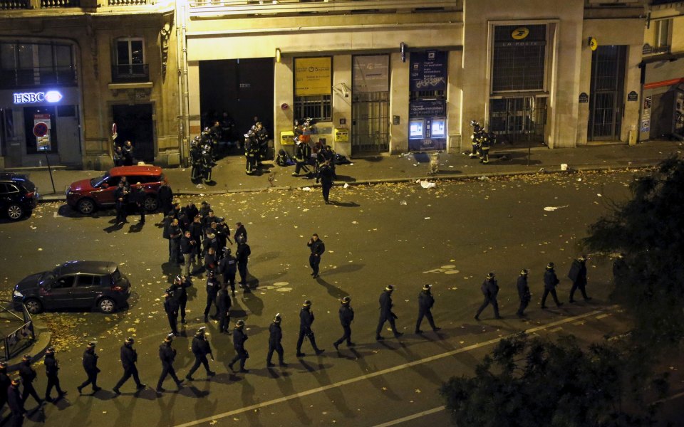  French police with protective shields walk in line near the Bataclan after the Paris attacks