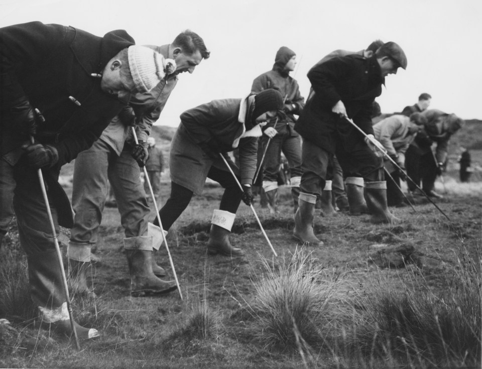  Searchers probing the peat on Saddleworth Moor