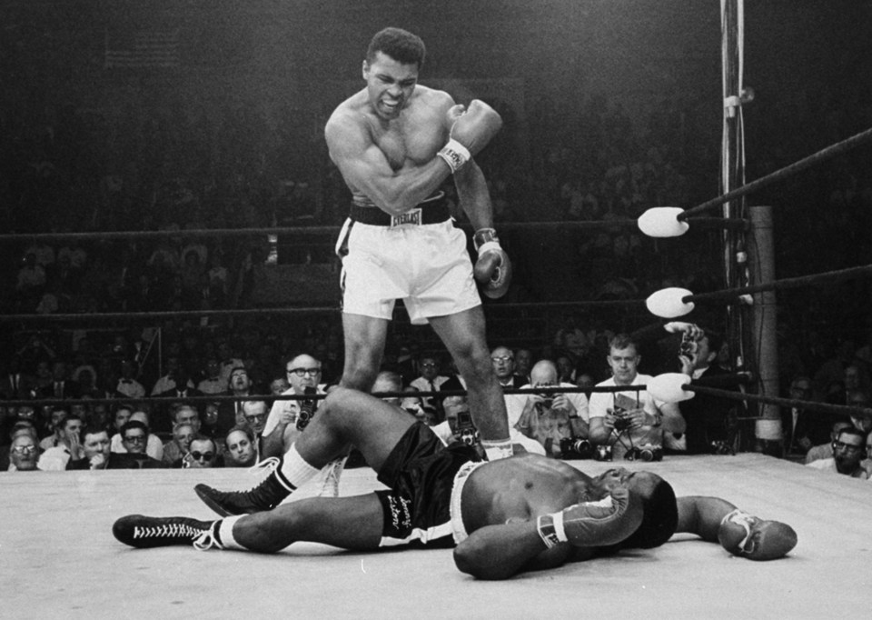 FILE - In this May 25, 1965 file photo, Heavyweight champion Muhammad Ali stands over fallen challenger Sonny Liston, shouting and gesturing shortly after dropping Liston with a short hard right to the jaw in Lewiston, Maine. Ali, the magnificent heavyweight champion whose fast fists and irrepressible personality transcended sports and captivated the world, has died according to a statement released by his family Friday, June 3, 2016. He was 74. (AP Photo/John Rooney)