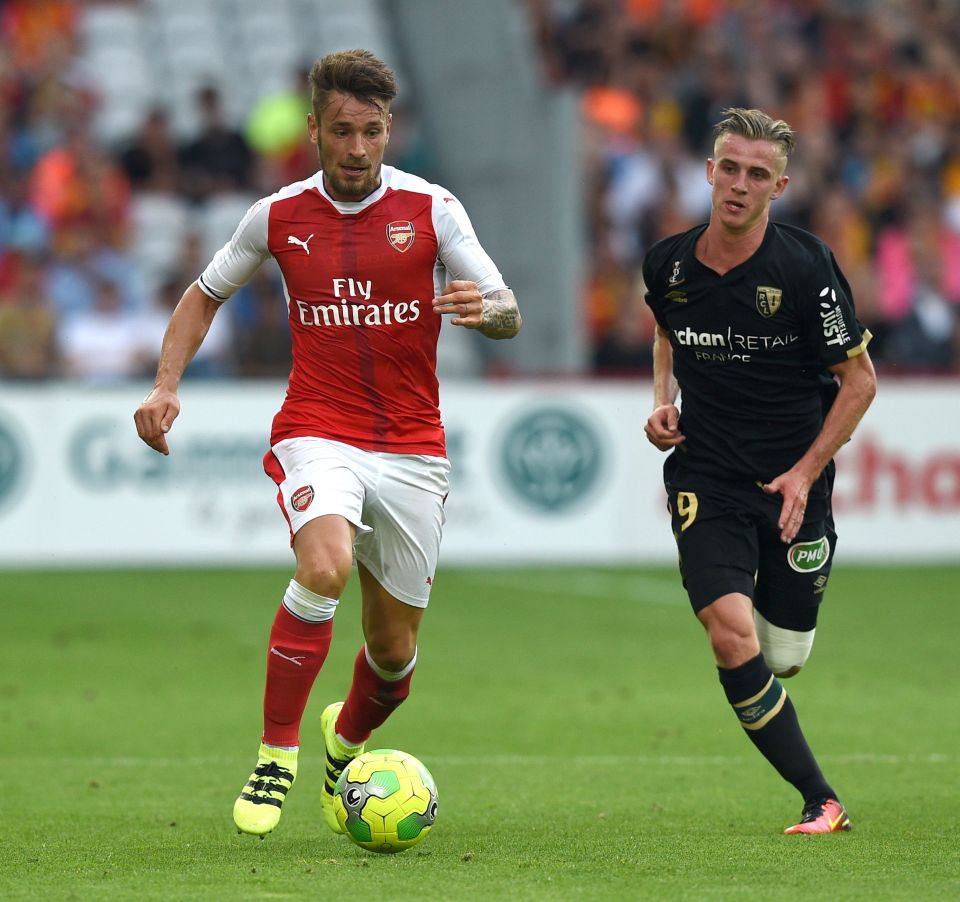 Arsenal's french defender Mathieu Debuchy vies with Lens's midfielder Benjamin Bourigeaud (R) during the football match Lens Vs Arsenal on July 22 2016, at the Felix Bollaert stadium in Lens. / AFP PHOTO / DENIS CHARLETDENIS CHARLET/AFP/Getty Images