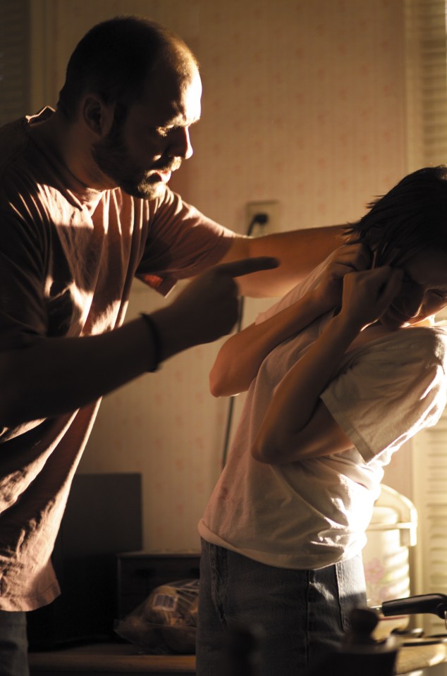 lifestyle photograph of a young caucasian couple as the man becomes angry and abusive