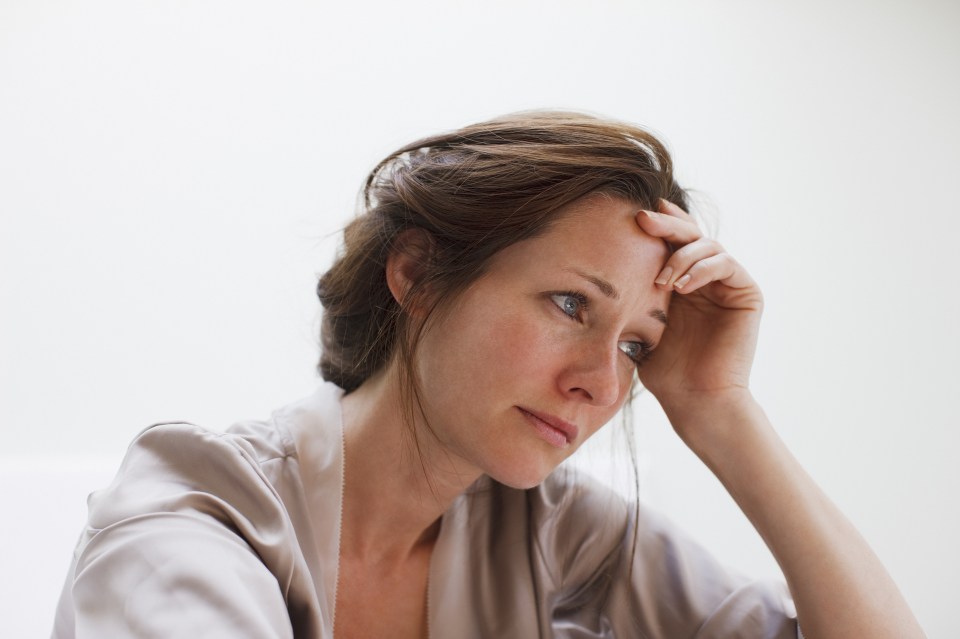 Depressed woman with head in hands