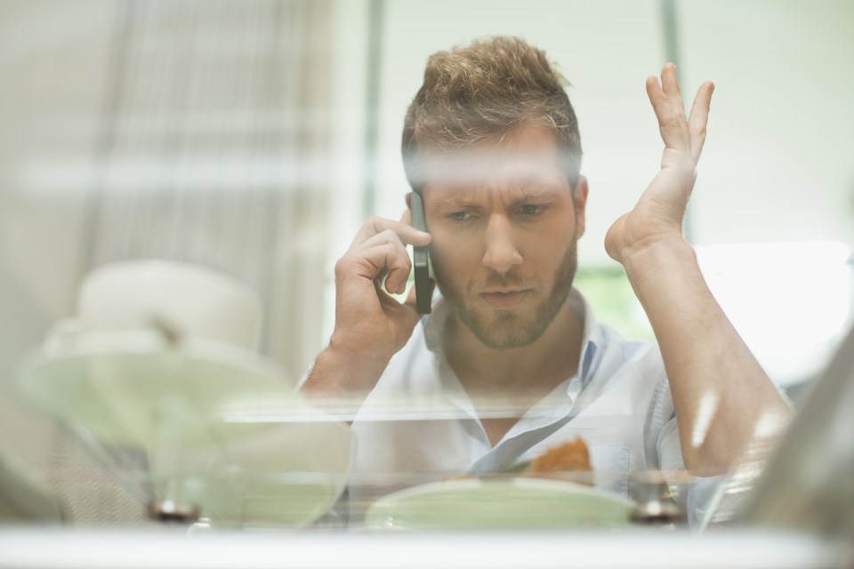 Man talking on cell phone at breakfast