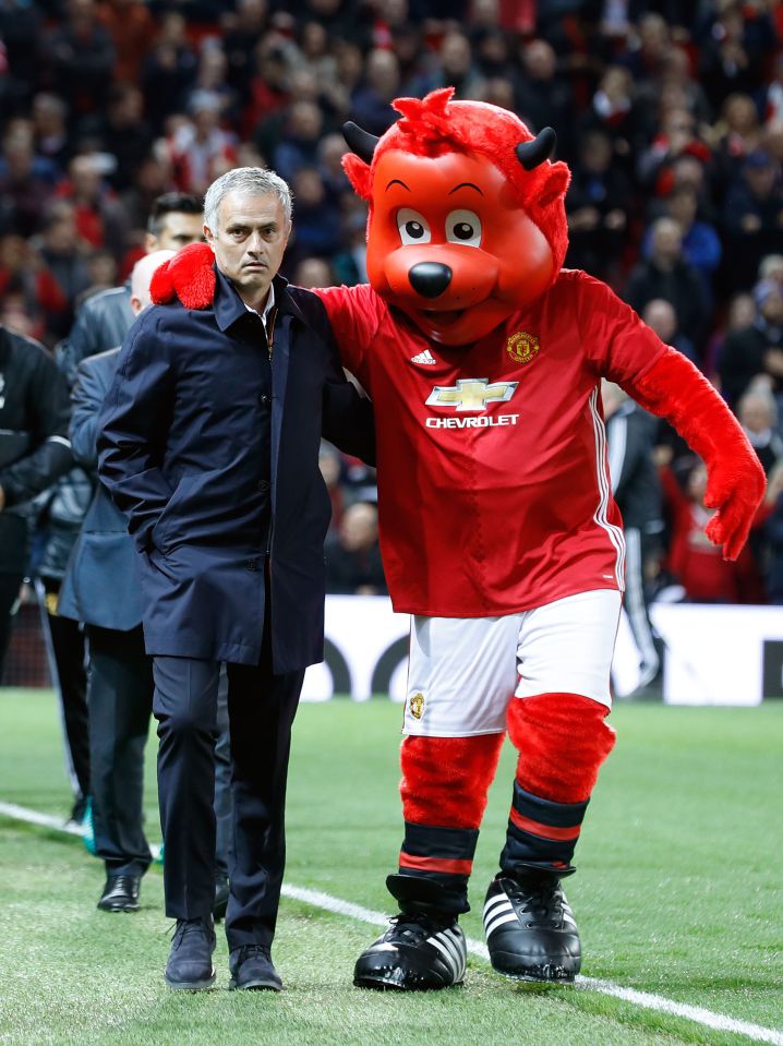 Fred the Red accompanies Jose Mourinho to the touchline