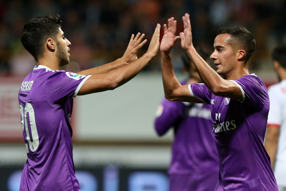 Real Madrid's midfielder Marco Asensio (L) celebrates a goal with Real Madrid's midfielder Lucas Vazquez during the Spanish Copa del Rey (King's Cup) round of 32 first leg football match between Cultural y Deportiva Leonesa and Real Madrid at the Reino de Leon stadium in Leon, on October 26, 2016. / AFP PHOTO / CESAR MANSOCESAR MANSO/AFP/Getty Images