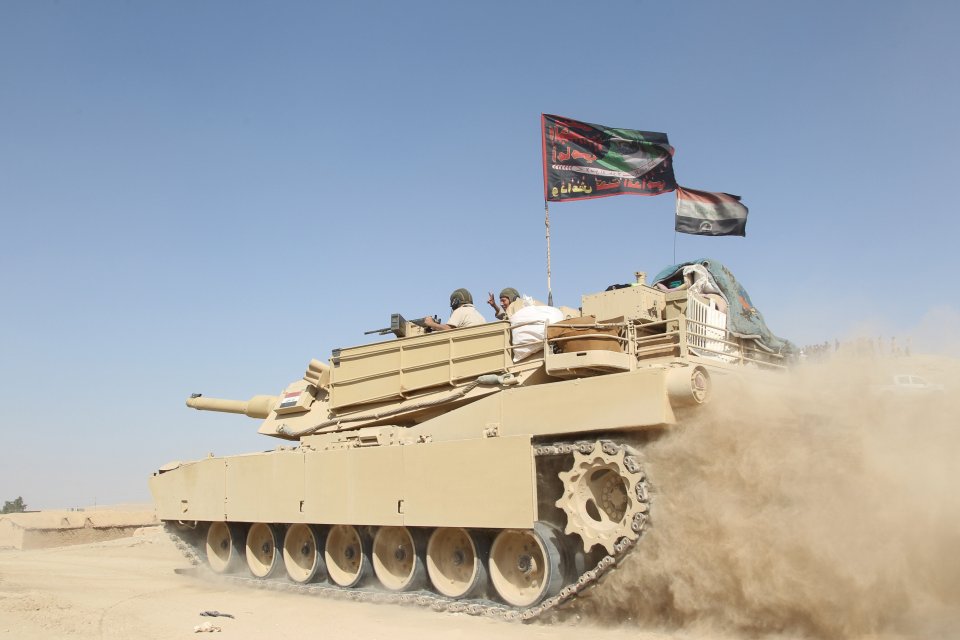  A tank from the Iraqi army drives south of the city