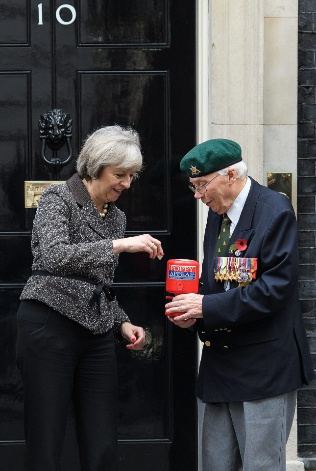 Theresa May Receives Her Remembrance Poppy From Veterans