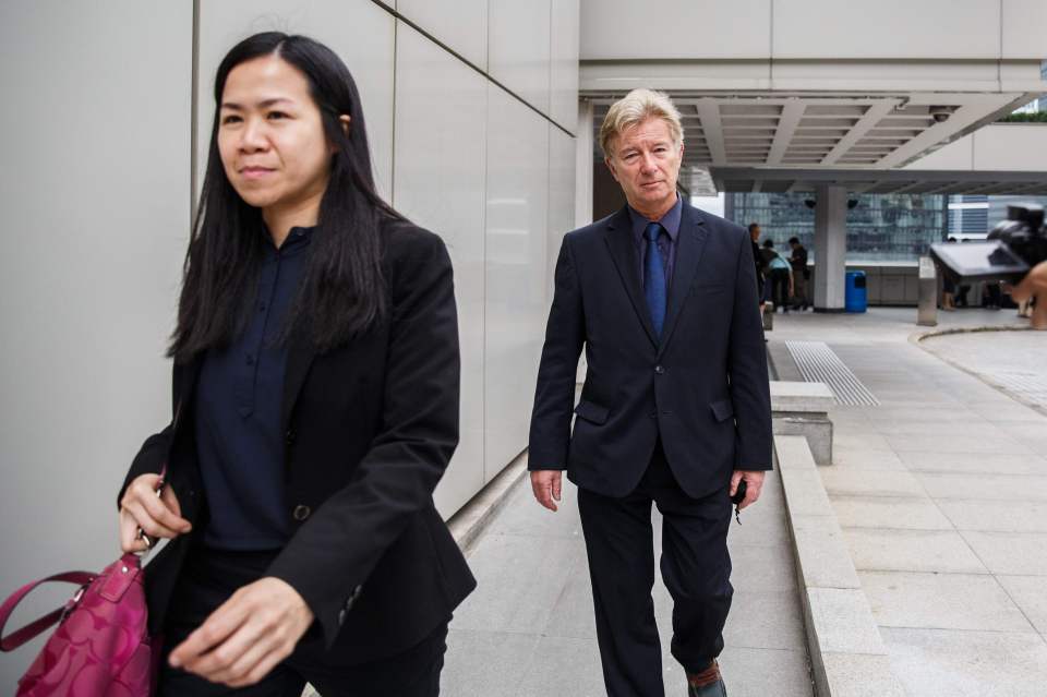  British psychologist Derek Perkins (right), a defence witness for Jutting, leaves court