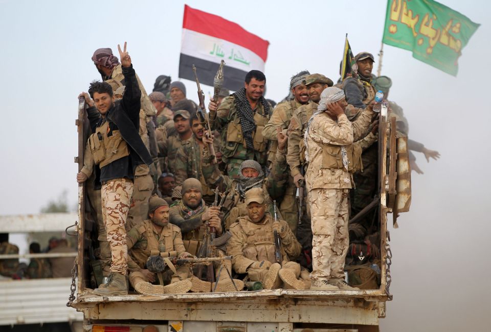  Shiite fighters flash the sign of victory as they drive towards south west Mosul